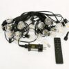 G40 LED String Lights Studio Product Photography Studio product photography of G40 LED dimmable string lights coiled with power plug, remote control, and warm glowing bulbs